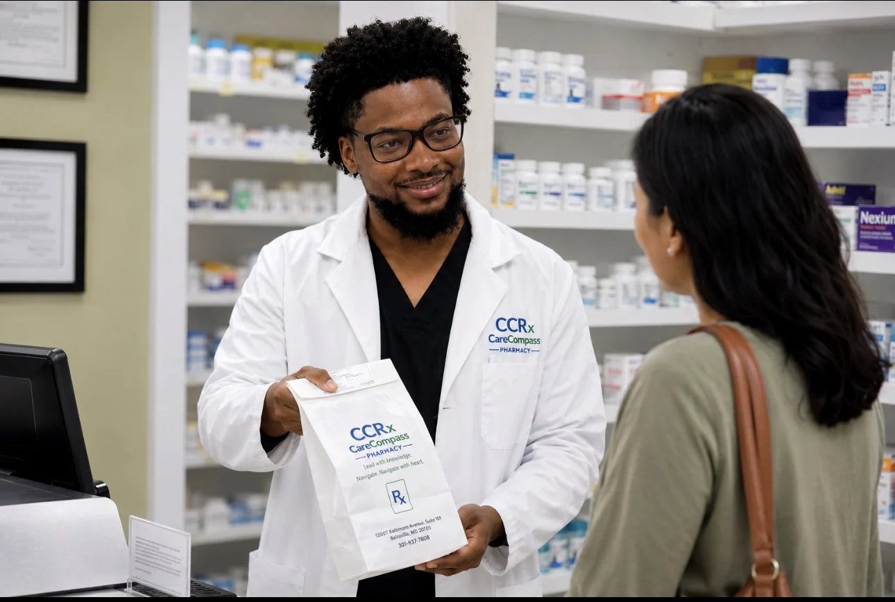 A CareCompass pharmacist provides a patient with a branded prescription package.