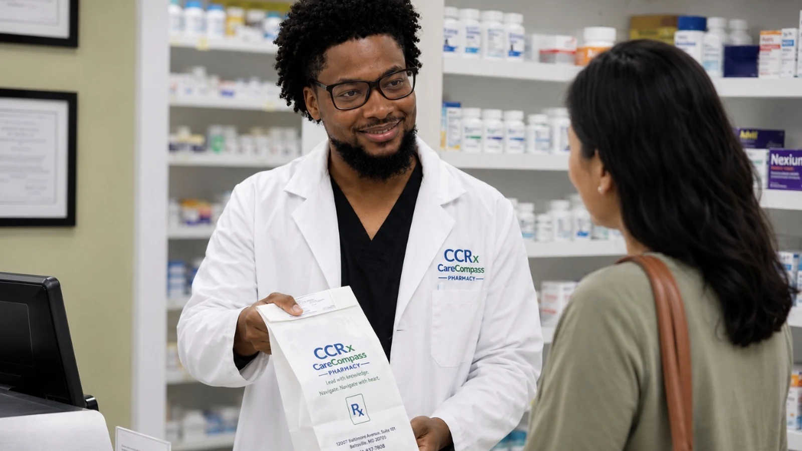 CareCompass pharmacist providing a prescription bag to a patient