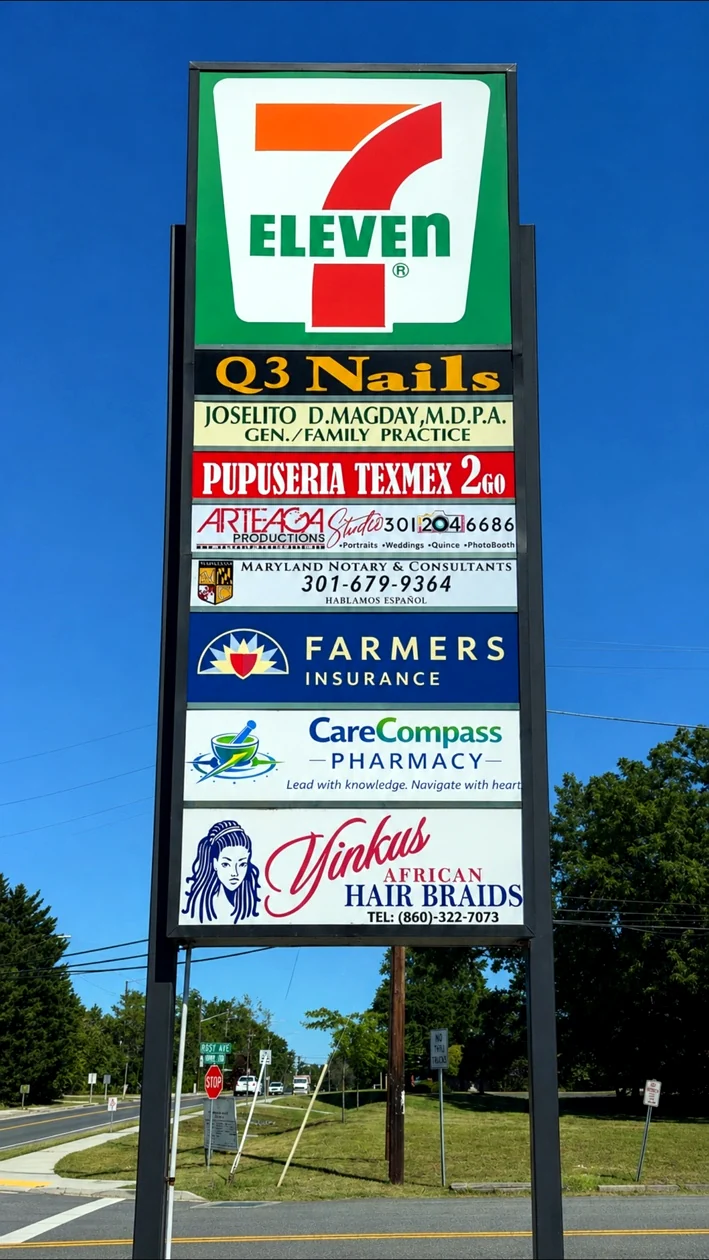 Roadside plaza sign showing CareCompass Pharmacy at the Roby Avenue location